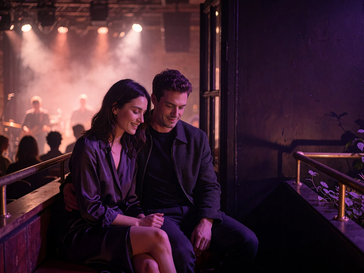 Couple seated on a private balcony overlooking a dim live-music room in downtown Nashville